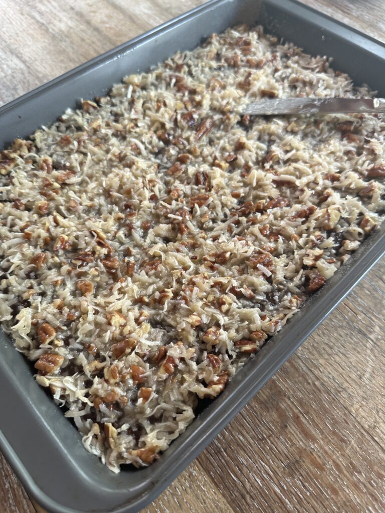 Spreading Coconut Topping Evenly on Hemp Oatmeal Cake