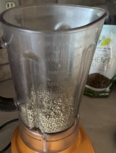whole hemp seeds in the blender being ground