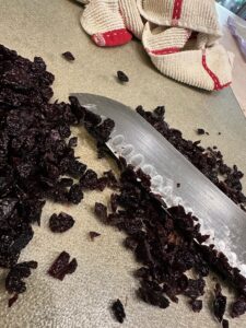 Hemp Seed Chocolate Cherry Bomb Clusters chopping the cherries